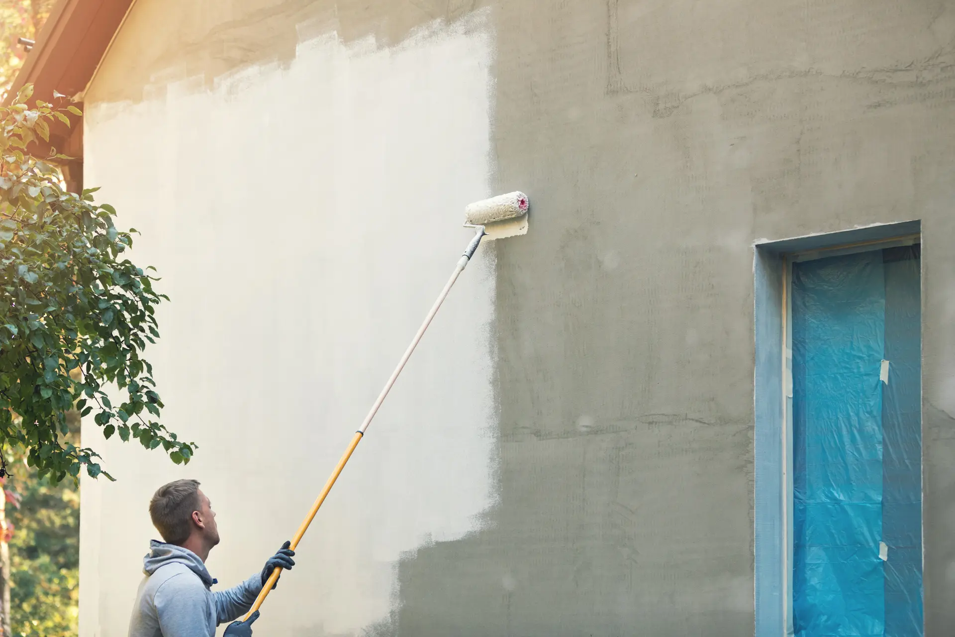 Pintor trabajando en una fachada en Vallecas